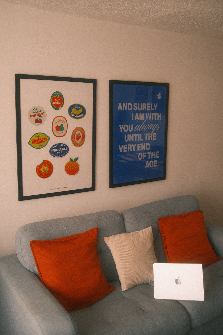 Fruit Stickers and I Am With You art prints on a living room wall